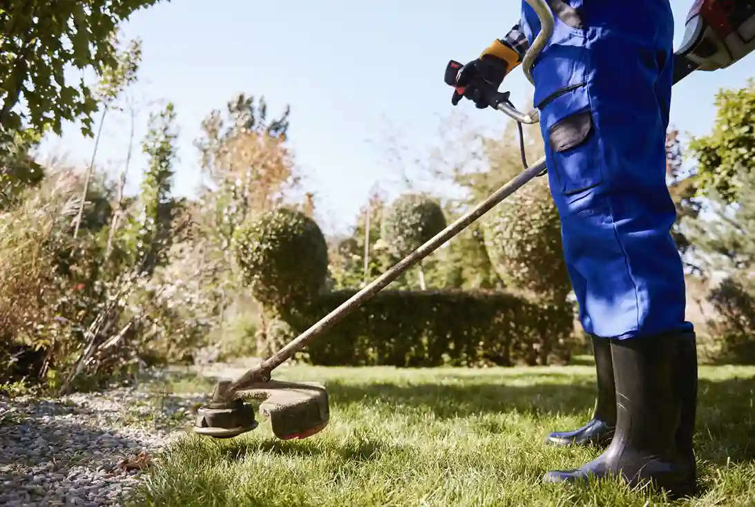 gardener-with-weedwacker-cutting-grass-garden-_1__11zon